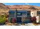 Striking modern two-story home boasting a desert landscape, neutral tones, and a mountain backdrop at 6197 Jewel Vista St, Las Vegas, NV 89135