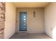 Contemporary home exterior featuring a stylish blue front door with unique window design at 6197 Jewel Vista St, Las Vegas, NV 89135