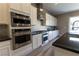 Modern kitchen features stainless steel appliances, granite counters, and ample white cabinetry at 6197 Jewel Vista St, Las Vegas, NV 89135