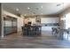 Bright, contemporary kitchen with stainless steel appliances, a center island, and a dining area, bathed in natural light at 6197 Jewel Vista St, Las Vegas, NV 89135