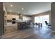 Gorgeous eat-in kitchen with stainless steel appliances, gray wood floors, and a center island with bar seating at 6197 Jewel Vista St, Las Vegas, NV 89135