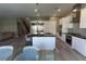Open-concept kitchen with stainless steel appliances, a center island with bar seating, and wood flooring, great for entertaining at 6197 Jewel Vista St, Las Vegas, NV 89135