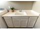 Close-up of the laundry room sink with white countertop and cabinets, complemented by a decorative plant at 6197 Jewel Vista St, Las Vegas, NV 89135