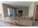 Cozy living room with neutral decor, large sectional sofa, and sliding glass door to the patio at 6197 Jewel Vista St, Las Vegas, NV 89135
