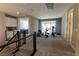 Spacious loft area with exercise equipment and access to a balcony at 6197 Jewel Vista St, Las Vegas, NV 89135