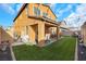 Expansive backyard with lush artificial turf, a covered patio, and ample space for relaxation and entertainment at 632 Loyalty Ct, Henderson, NV 89011