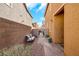 Private backyard featuring low-maintenance landscaping, a charming bench, and secure gated access at 632 Loyalty Ct, Henderson, NV 89011