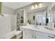 Bright bathroom with a tub, shower, and vanity with a decorative mirror at 632 Loyalty Ct, Henderson, NV 89011