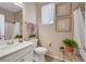 Bright bathroom with a modern sink, neutral tones, and tasteful decorative accents and plants at 632 Loyalty Ct, Henderson, NV 89011