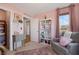 Pink Bedroom featuring a comfortable chair, bookcase, and closet access at 632 Loyalty Ct, Henderson, NV 89011