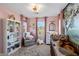A pink Bedroom featuring natural lighting, a rocking horse, and tree art at 632 Loyalty Ct, Henderson, NV 89011