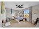 Sun-filled bedroom featuring a ceiling fan, a bed with storage, and a window view at 632 Loyalty Ct, Henderson, NV 89011