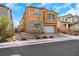 Two-story home with stone accents, well-manicured landscaping, and a two-car garage with brick driveway at 632 Loyalty Ct, Henderson, NV 89011