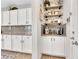Convenient coffee bar area in the kitchen, adjacent to white cabinets and backsplash at 632 Loyalty Ct, Henderson, NV 89011