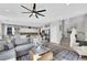 Bright and spacious living room featuring a ceiling fan, modern decor, and seamless access to the kitchen at 632 Loyalty Ct, Henderson, NV 89011