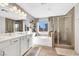 Bright en-suite bathroom features a double vanity, soaking tub, and glass-enclosed shower at 632 Loyalty Ct, Henderson, NV 89011
