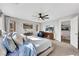 Cozy main bedroom featuring a ceiling fan, contemporary decor, and view into the upstairs hall at 632 Loyalty Ct, Henderson, NV 89011