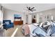 Well-lit main bedroom with a cozy sitting area, ceiling fan, and view of the en-suite bathroom at 632 Loyalty Ct, Henderson, NV 89011