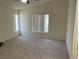 Bright bedroom with neutral carpet, large windows, and vaulted ceilings for a serene atmosphere at 6462 Saddle Up Ave # 103, Henderson, NV 89011