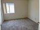 A cozy bedroom with neutral walls, carpet, and a bright window for ample natural light at 6462 Saddle Up Ave # 103, Henderson, NV 89011