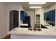 Modern kitchen with blue cabinets, a breakfast bar, stainless steel appliances, and white countertops at 6462 Saddle Up Ave # 103, Henderson, NV 89011