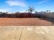Spacious backyard featuring a gravel landscape, fenced perimeter, and a concrete patio area, perfect for outdoor living at 6479 Gunderson Blvd, Las Vegas, NV 89103