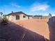 Gravel-filled backyard featuring a sliding glass door entrance to home, landscaped area and privacy fence at 6479 Gunderson Blvd, Las Vegas, NV 89103