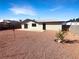 Gravel-filled backyard showcasing a patio area, sliding glass doors, and a simple, low-maintenance design at 6479 Gunderson Blvd, Las Vegas, NV 89103