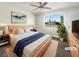 Staged bedroom featuring a large window, ceiling fan, and stylish decor at 6479 Gunderson Blvd, Las Vegas, NV 89103
