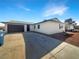 Charming single-story home featuring a two-car garage and a well-maintained front yard with desert landscaping at 6479 Gunderson Blvd, Las Vegas, NV 89103
