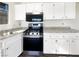 Modern kitchen with stainless steel oven, microwave, granite counters, and white cabinets at 6479 Gunderson Blvd, Las Vegas, NV 89103