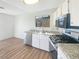 Modern kitchen with stainless steel appliances, granite counters, and hardwood floors at 6479 Gunderson Blvd, Las Vegas, NV 89103