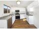 Updated kitchen with white cabinets, granite countertops, stainless steel appliances, and wood-look flooring at 6479 Gunderson Blvd, Las Vegas, NV 89103