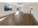 Open-concept living area with wood-look flooring, natural light, and direct access to the kitchen and backyard at 6479 Gunderson Blvd, Las Vegas, NV 89103