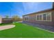 Enjoy a relaxing hot tub, manicured lawn, and low-maintenance landscaping in this backyard at 6602 Windy Palm St, North Las Vegas, NV 89086