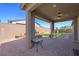Covered patio overlooks backyard with a unique fire pit and manicured landscaping at 6602 Windy Palm St, North Las Vegas, NV 89086