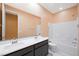 Bathroom with double sink vanity and shower over bath at 6602 Windy Palm St, North Las Vegas, NV 89086