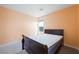 This bedroom features neutral carpet, a large window and modern lighting at 6602 Windy Palm St, North Las Vegas, NV 89086