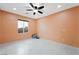 Bedroom with tile floors, ceiling fan, and natural light at 6602 Windy Palm St, North Las Vegas, NV 89086
