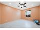 Bedroom with tile floors, ceiling fan, and natural light at 6602 Windy Palm St, North Las Vegas, NV 89086