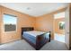 This bedroom features neutral carpet, a large window and modern lighting at 6602 Windy Palm St, North Las Vegas, NV 89086