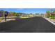 Gated community entrance with landscaped median and security check-in for added peace of mind at 6602 Windy Palm St, North Las Vegas, NV 89086
