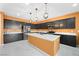 Modern kitchen with stainless steel appliances, center island, dark cabinets, and designer pendant lighting at 6602 Windy Palm St, North Las Vegas, NV 89086