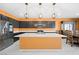 Modern kitchen with stainless steel appliances, center island, dark cabinets, and designer pendant lighting at 6602 Windy Palm St, North Las Vegas, NV 89086