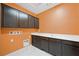 This laundry room features sleek cabinets and a convenient layout at 6602 Windy Palm St, North Las Vegas, NV 89086