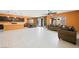 Open concept living room with modern tile flooring and a wall of sliding glass doors at 6602 Windy Palm St, North Las Vegas, NV 89086