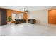 Bright living room featuring two sofas, a modern ceiling fan, and sleek tile flooring at 6602 Windy Palm St, North Las Vegas, NV 89086
