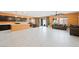 Open concept living room with modern tile flooring and a wall of sliding glass doors at 6602 Windy Palm St, North Las Vegas, NV 89086