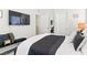 Modern bedroom with a TV, bench, and stylish decor at 7350 N Decatur Blvd # 5, Las Vegas, NV 89131