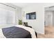 Bright bedroom with a wall-mounted TV and a comfortable bench seating area at 7350 N Decatur Blvd # 5, Las Vegas, NV 89131